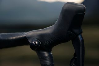 Trek's Domane+ SLR e-road bike uses buttoms attached to the handlebars to change between assist modes