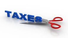 Scissors cut the word "taxes" in half horizontally.