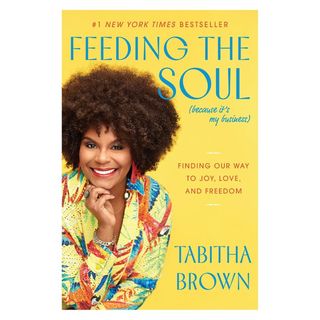 A yellow book titled 'Feeding the Soul' with a person smiling on the cover