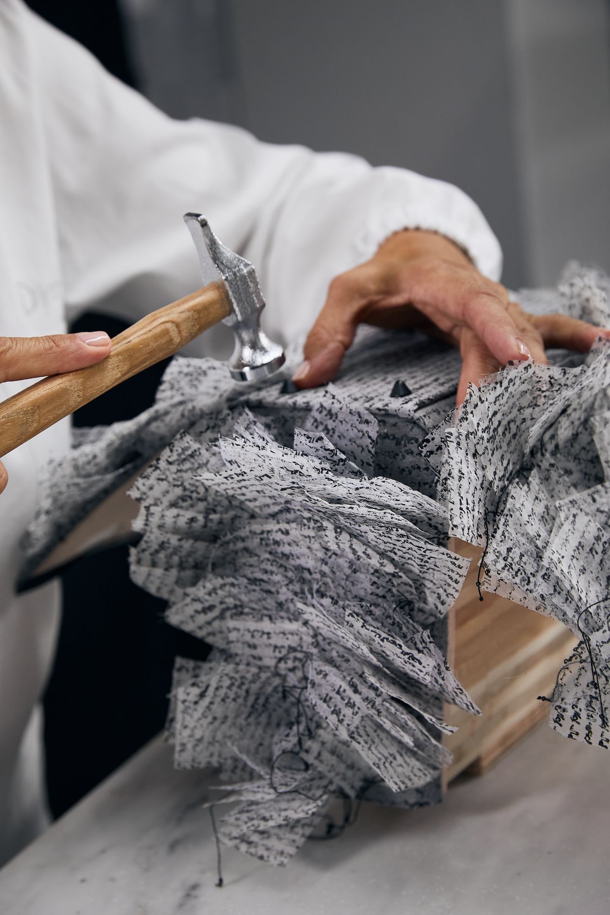 Person working on a Lady Dior bag design