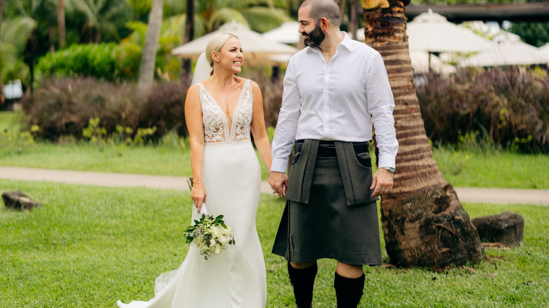 Kelly and Graham at their Seychelles wedding, Graham wearing a kilt and Kelly wearing a white dress