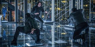 John Wick (Keanu Reeves) trying to not get thrown through glass in John Wick: Chapter 3 -- Parabellum