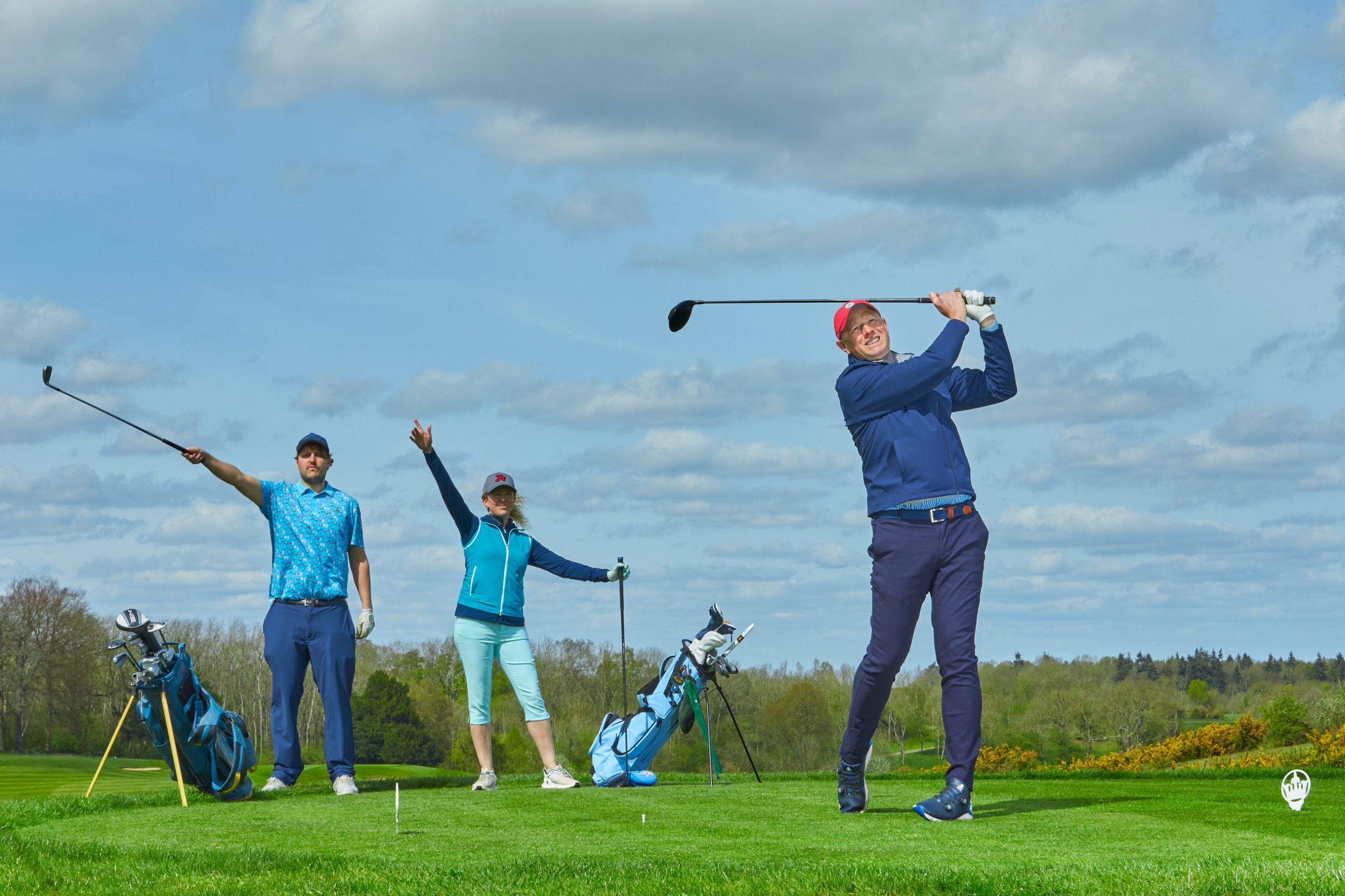 Two playing partners pointing right after a drive to signal where the ball has gone