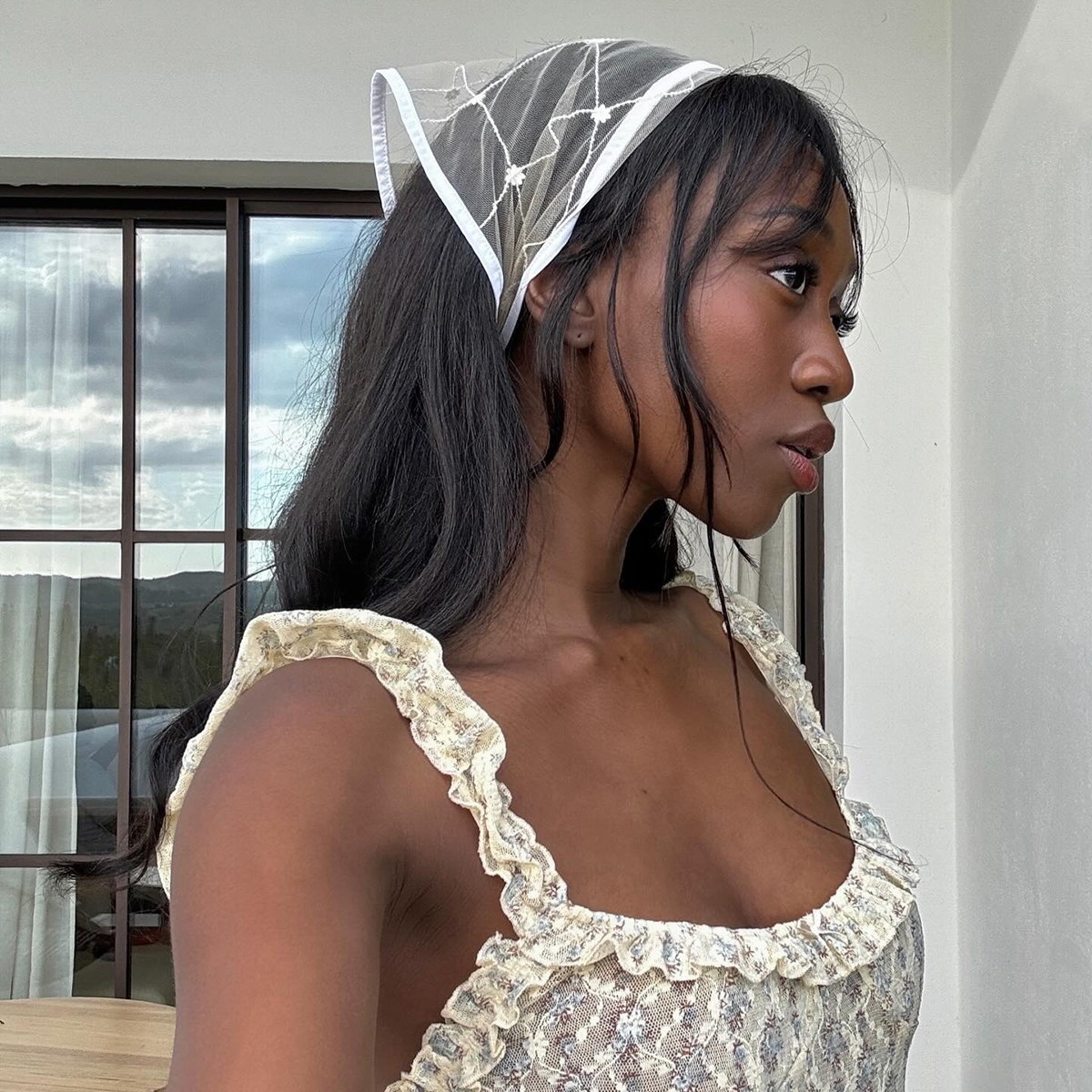 French influencer wearing a lace head scarf