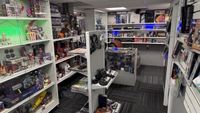 Photographs of custom game store collection display with dozens of games and boxes on shelves