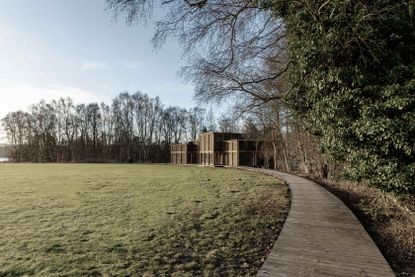 House of Nature by Revaerk Arkitektur as seen from afar within green nature