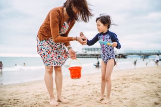 Mother and daughter on the beach in the UK