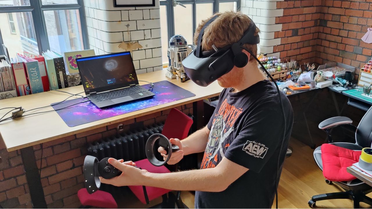 Man playing with HP Reverb G2 VR headset and controllers. He is holding the controllers like a gun.