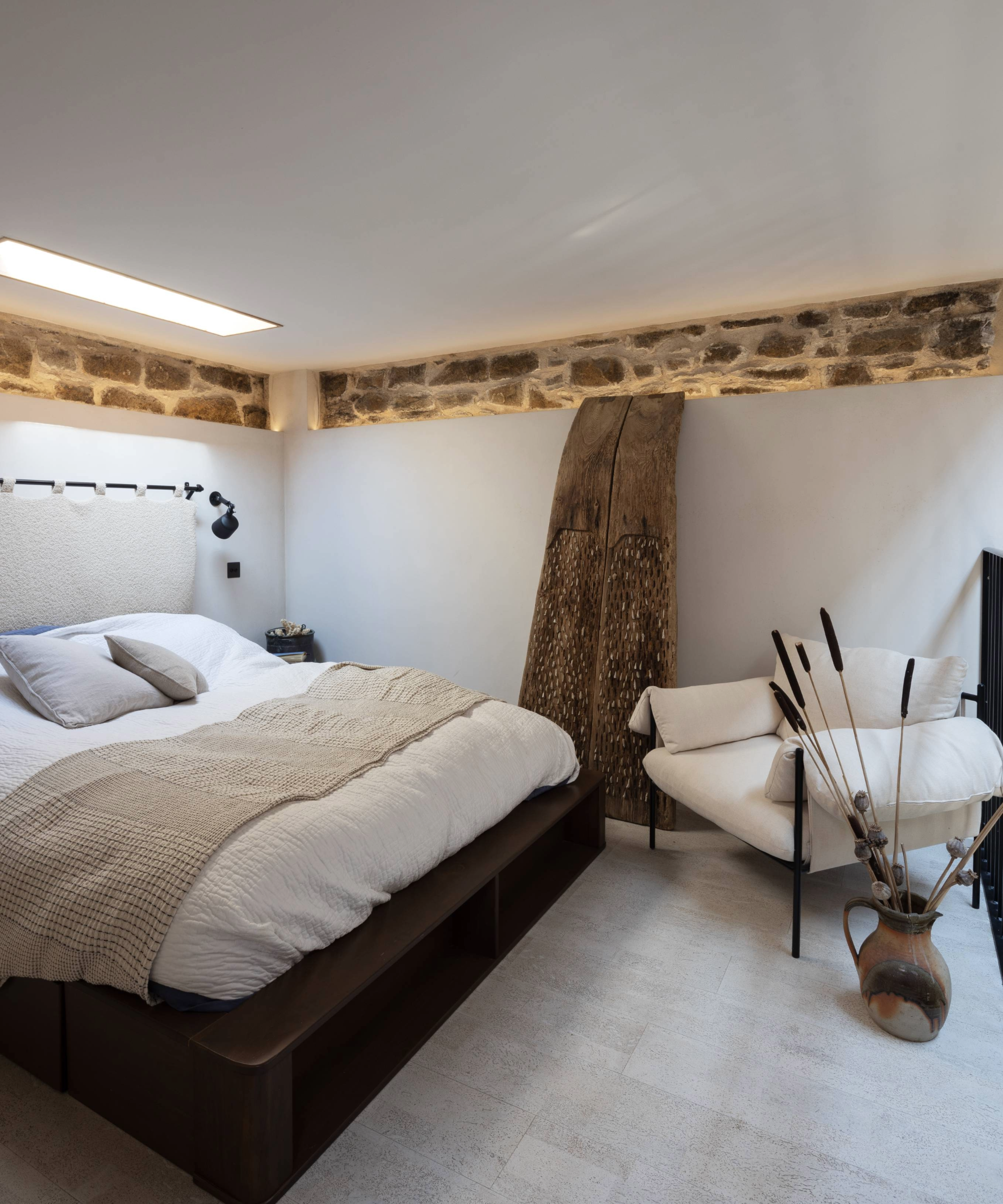 Bedroom with exposed brick, rooflight, wooden beam