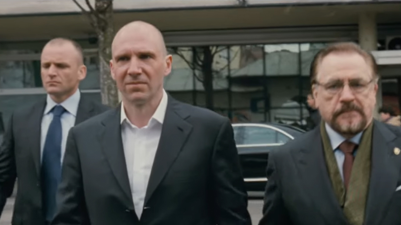 Ralph Fiennes and Brian Cox walking in suits