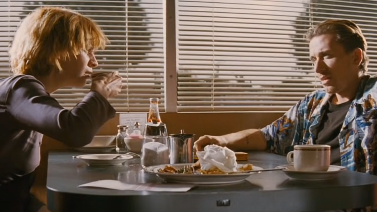 Amanda Plummer drinking coffee in a booth with Tim Roth in the opening scene of Pulp Fiction