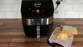 The ingredients to make a grilled cheese stacked up on a bread board by the Instant Vortex Plus 6-in1 air fryer