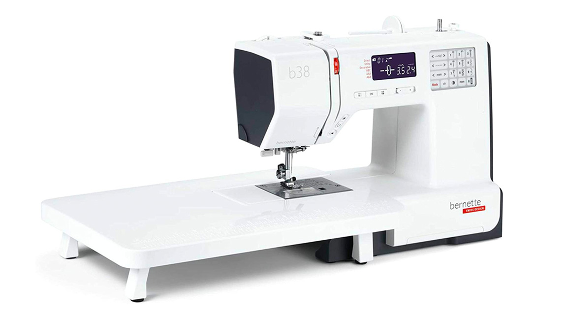 Best Sewing Machines For Quilting;  a large white sewing machine with an attached extension table