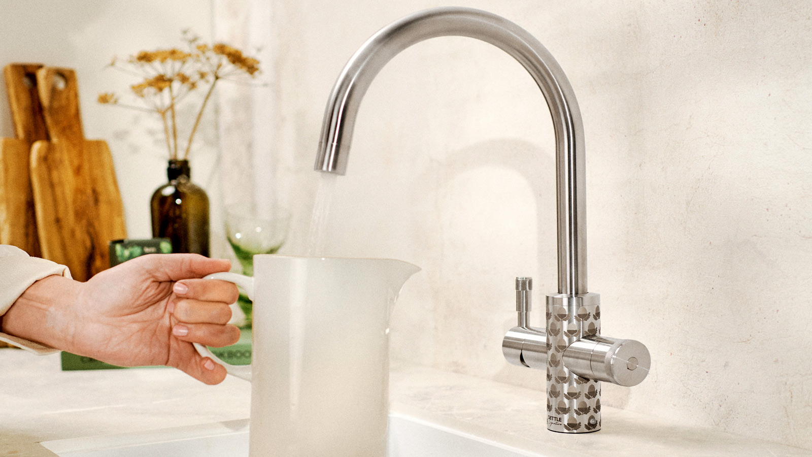 Chrome Qettle single column tap in kitchen adding water to plastic jug