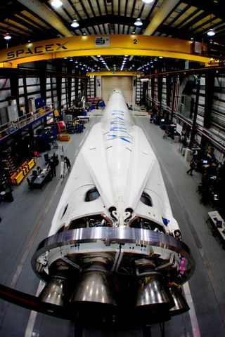 SpaceX Falcon 9 v1.1 rocket, equipped with landing legs, awaits launch in the private spaceflight company's hangar at Cape Canaveral, Fla. Image added March 11, 2014.