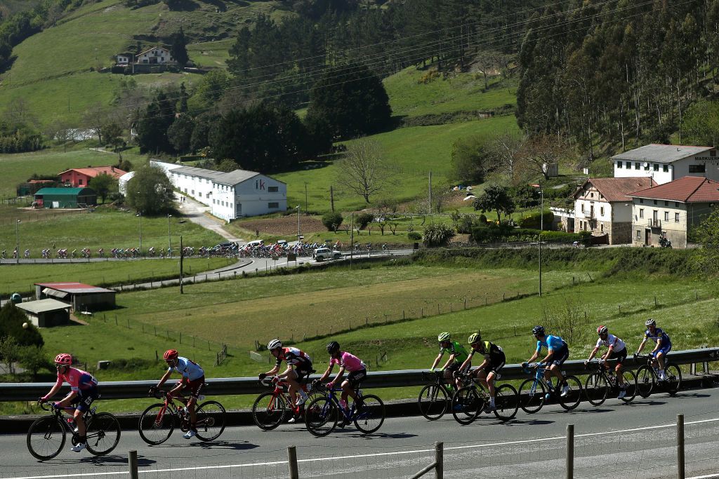 The peloton loom ominously down the road from the break