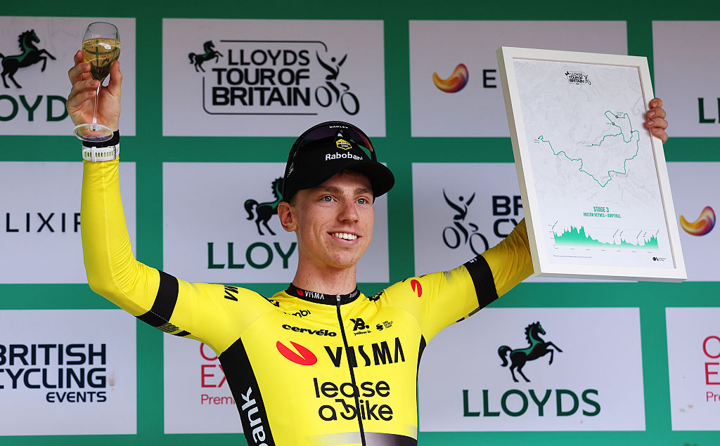 AMPTHILL, ENGLAND - SEPTEMBER 04: Matthew Brennan of Great Britain and Team Visma | Lease a Bike celebrates at podium as stage winner as stage winner during the 21st Tour of Britain 2025, Stage 3 a 122.8km stage from Milton Keynes to Ampthill on September 04, 2025 in Ampthill, England. (Photo by Alex Livesey/Getty Images)