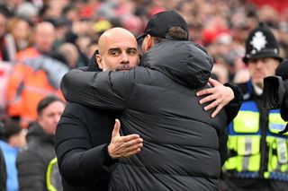 Pep Guardiola, Manager of Manchester City, and Jurgen Klopp, Manager of Liverpool, embrace prior to the Premier League match between Liverpool FC and Manchester City at Anfield on March 10, 2024 in Liverpool, England.