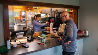 A golfer ordering food and drink at the halfway hut at Gleneagles