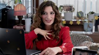 Esmeralda talks to the cameras while sat behind her desk