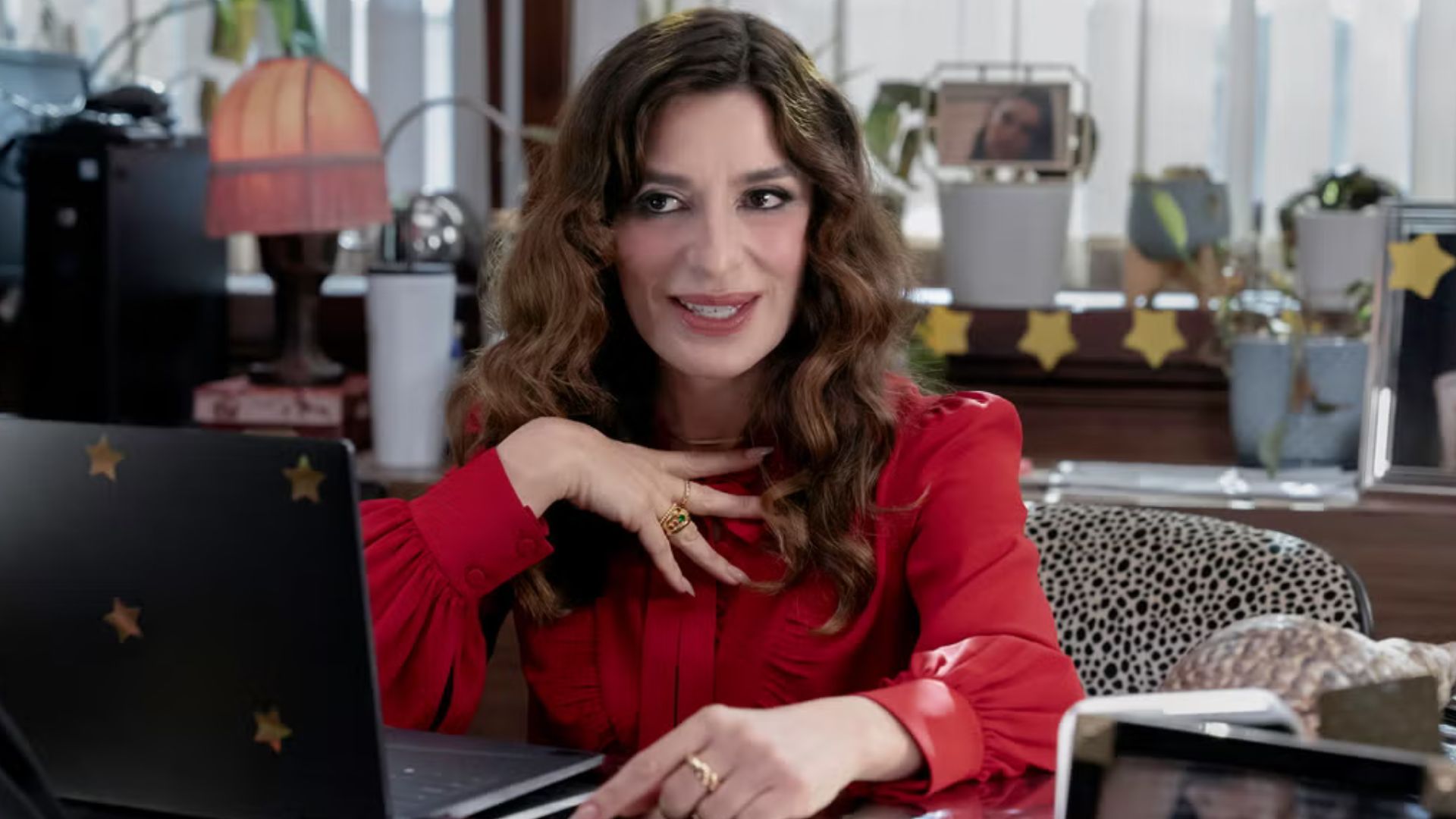 Esmeralda talks to the cameras while sat behind her desk