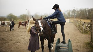 Rider mounting a horse