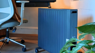 heater next to plant and chair