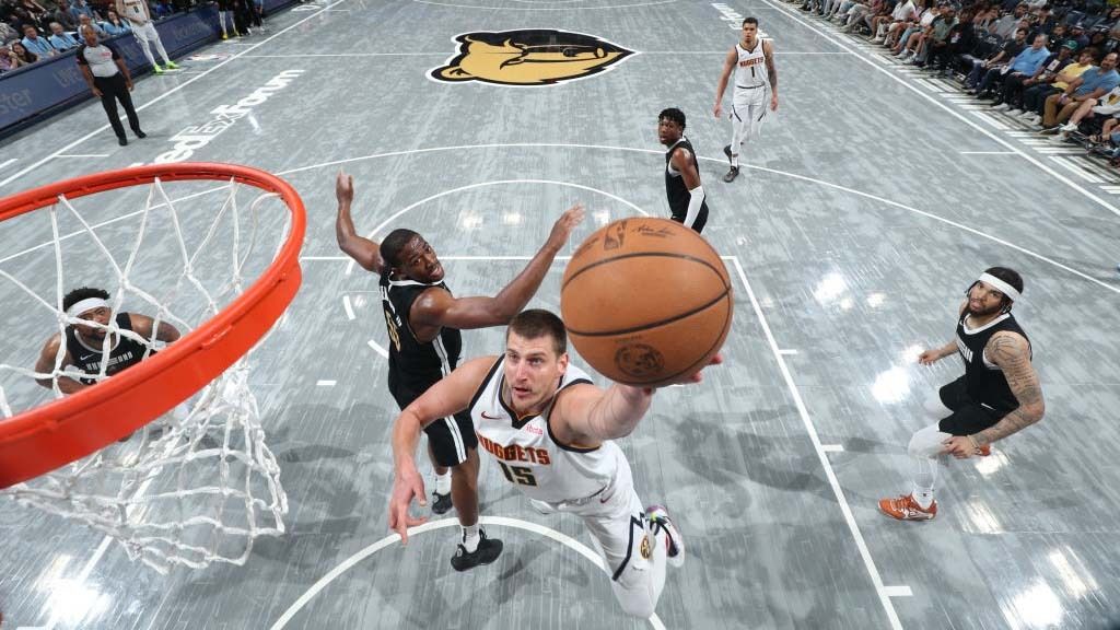 Nikola Jokic #15 of the Denver Nuggets drives to the basket during the game against the Memphis Grizzlies on April 14, 2024 