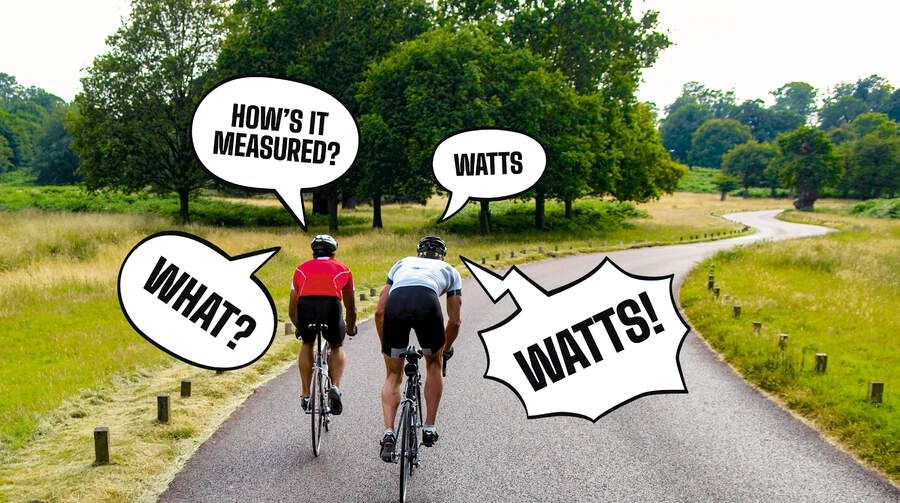 Two cyclists ride side by side discussing the use of a power meter