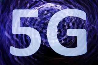 In this photo illustration 5G sign is seen on the smartphone screen with keyboard in the background in this multiple exposure illustration photo taken in in Poland on June 5, 2020. (Photo illustration by Jakub Porzycki/NurPhoto via Getty Images)