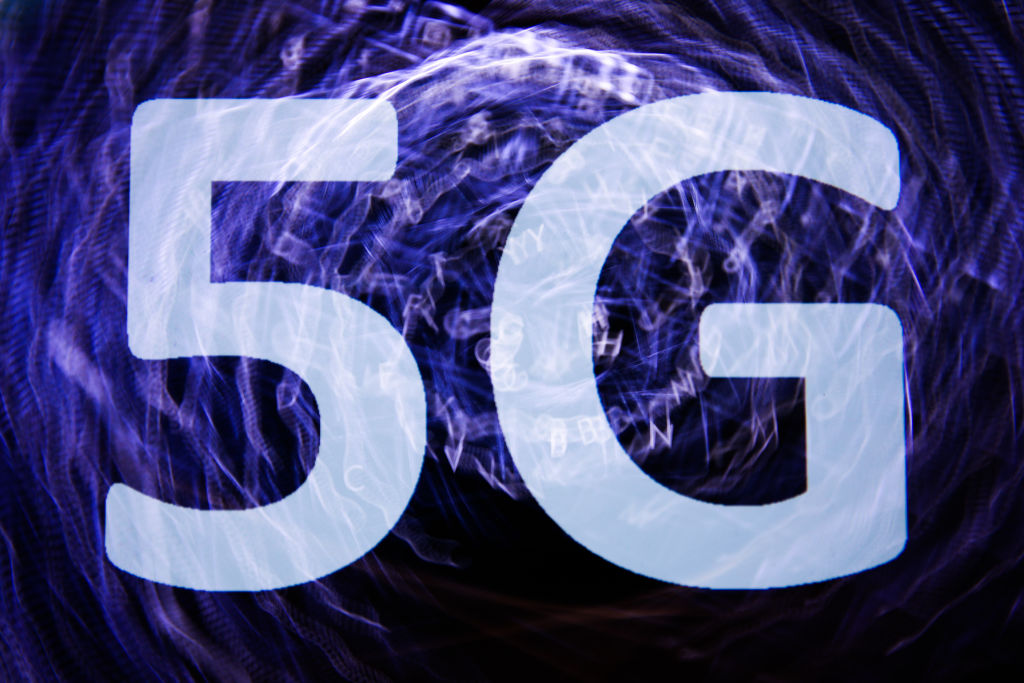In this photo illustration 5G sign is seen on the smartphone screen with keyboard in the background in this multiple exposure illustration photo taken in in Poland on June 5, 2020. (Photo illustration by Jakub Porzycki/NurPhoto via Getty Images)