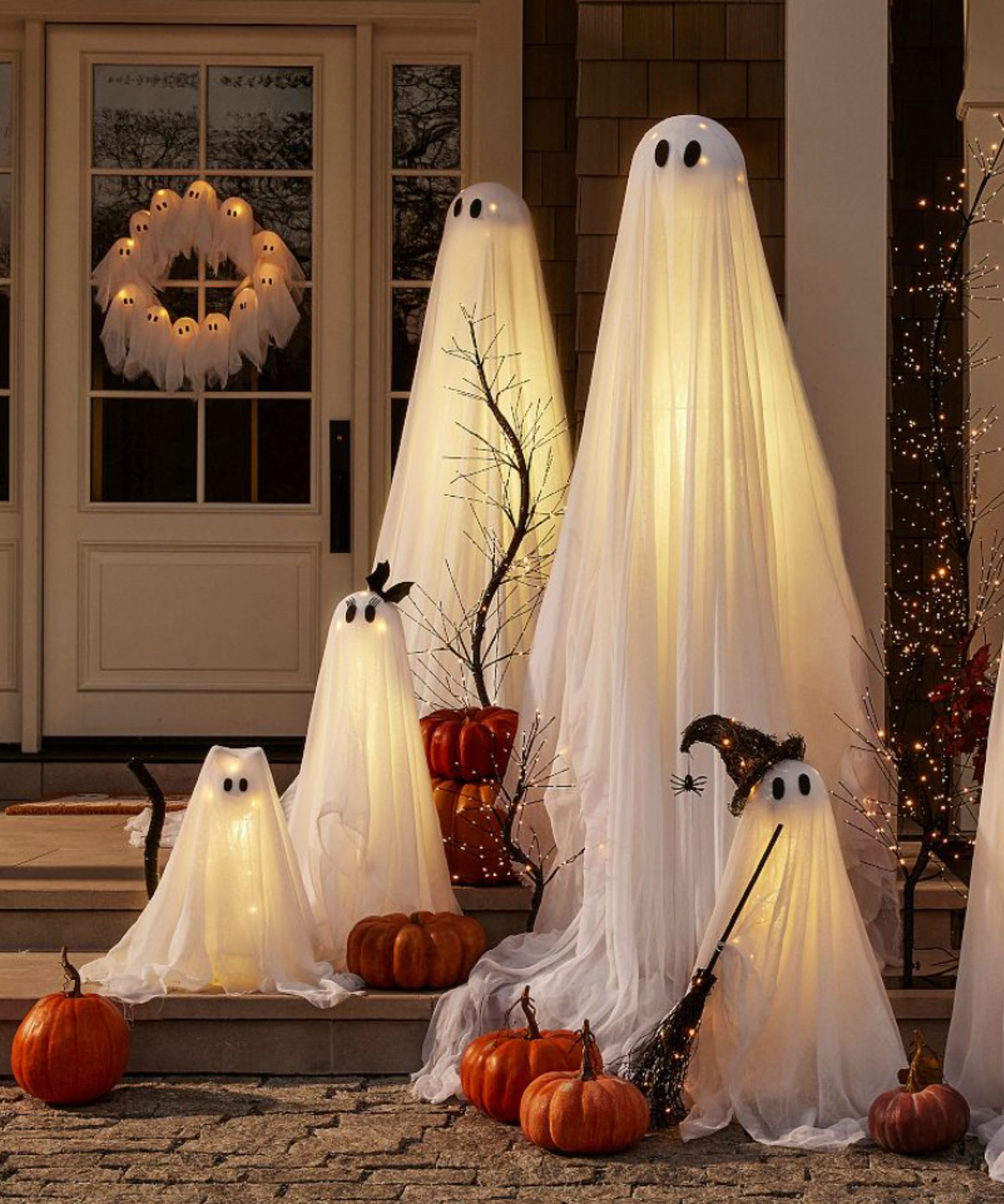 Lit ghost decorations on a porch