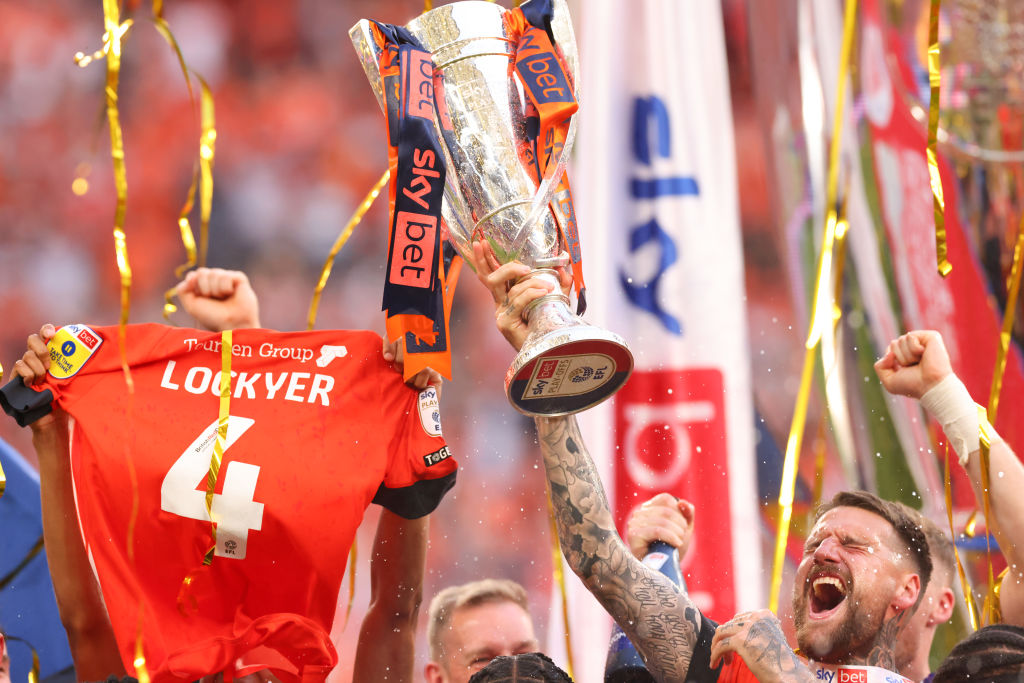 LONDON, ENGLAND - MAY 27: Sonny Bradley of Luton Town celebrates with the trophy alongside the shirt of Tom Lockyer during the Sky Bet Championship Play-Off Final match between Coventry City and Luton Town at Wembley Stadium on May 27, 2023 in London, England. (Photo by Marc Atkins/Getty Images)