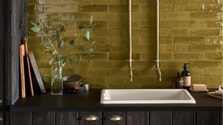 Rustic bathroom with olive tiles and exposed taps