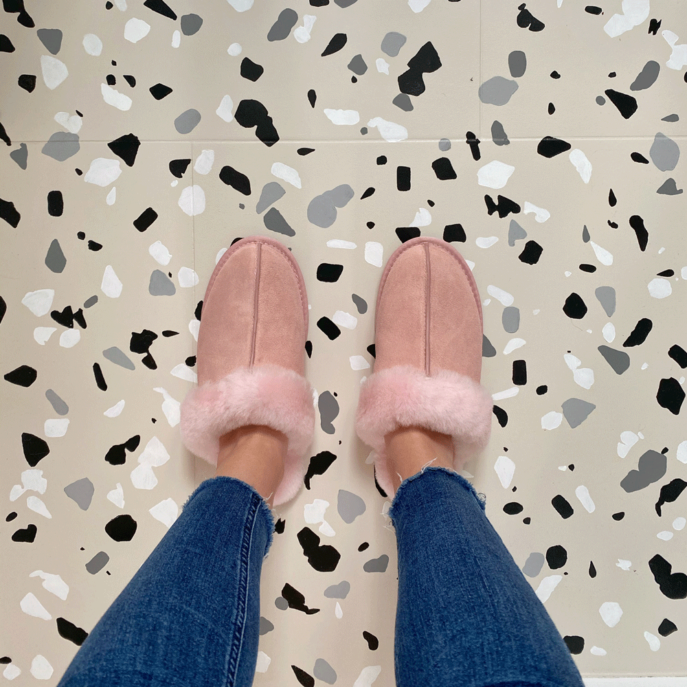 lady with terrazzo tiles pink shoes and jeans