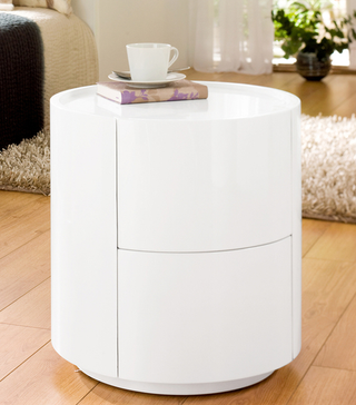 Sphere Gloss White Bedside Table on laminate wooden floor next to beige rug