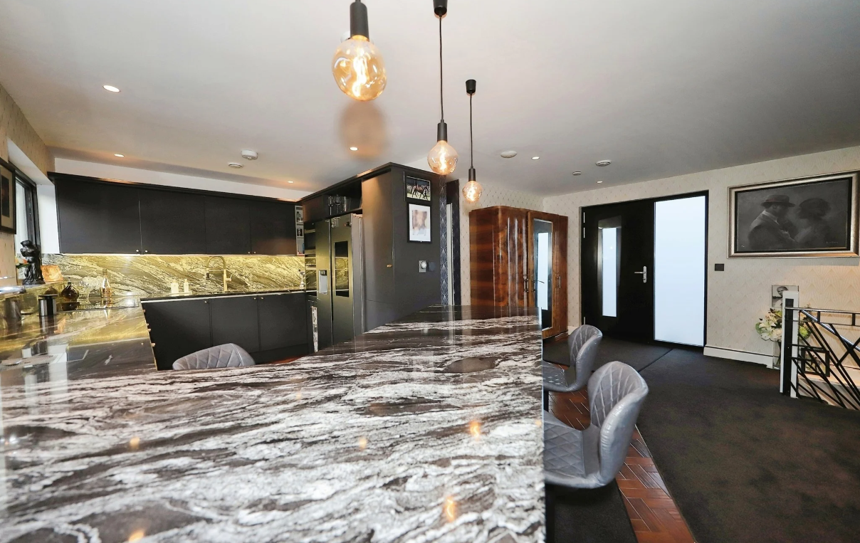 A marble worktop and overhead lighting