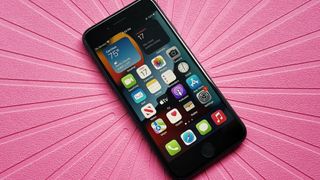 Black iPhone SE 2022 on pink background