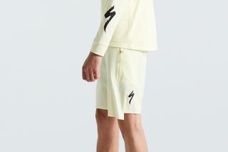 Pastel yellow trail shorts with a black Specialized S logo