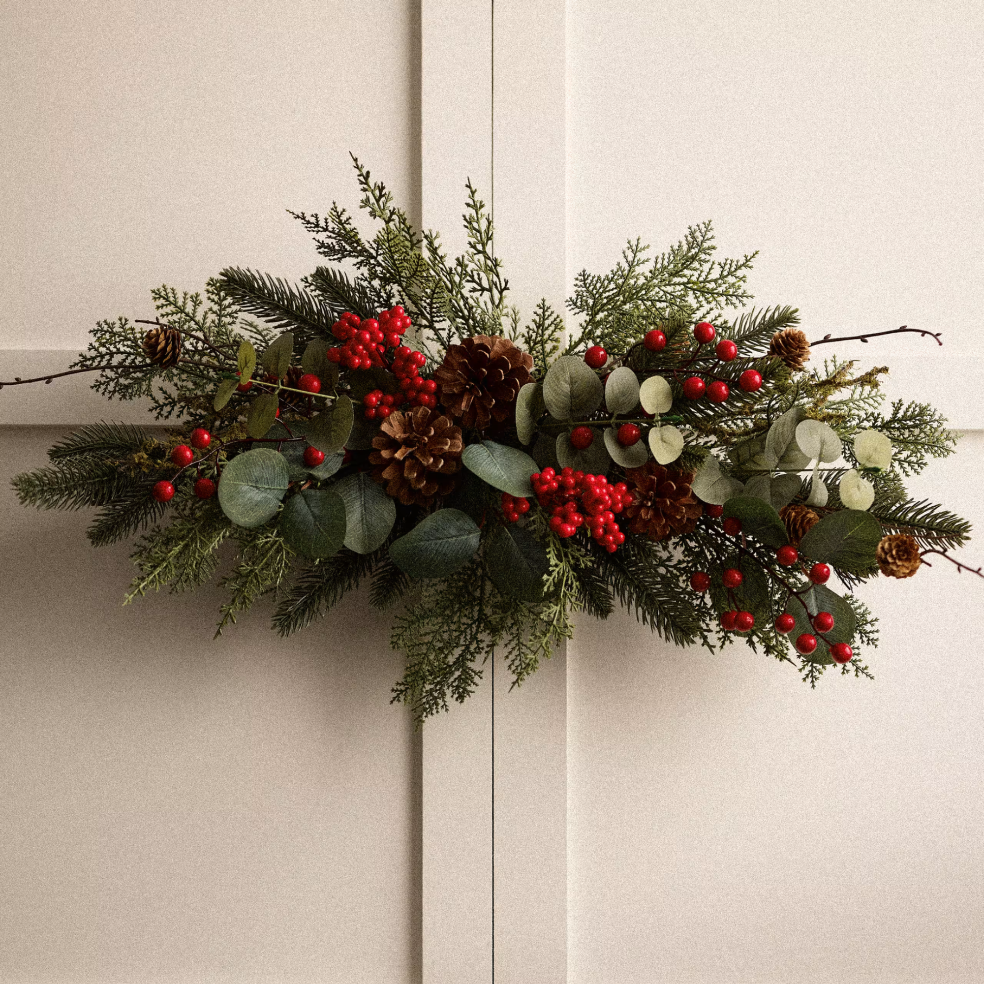 Red Berry Half Moon Wreath hanging on door.