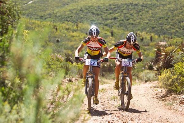 Erik Kleinhans pushes his wife Ariane up a steep climb on their way to overall Mixed category victory in 2011. The Mixed is one of seven categories at the 2012 Bridge Cape Pioneer Trek mountain bike stage race.