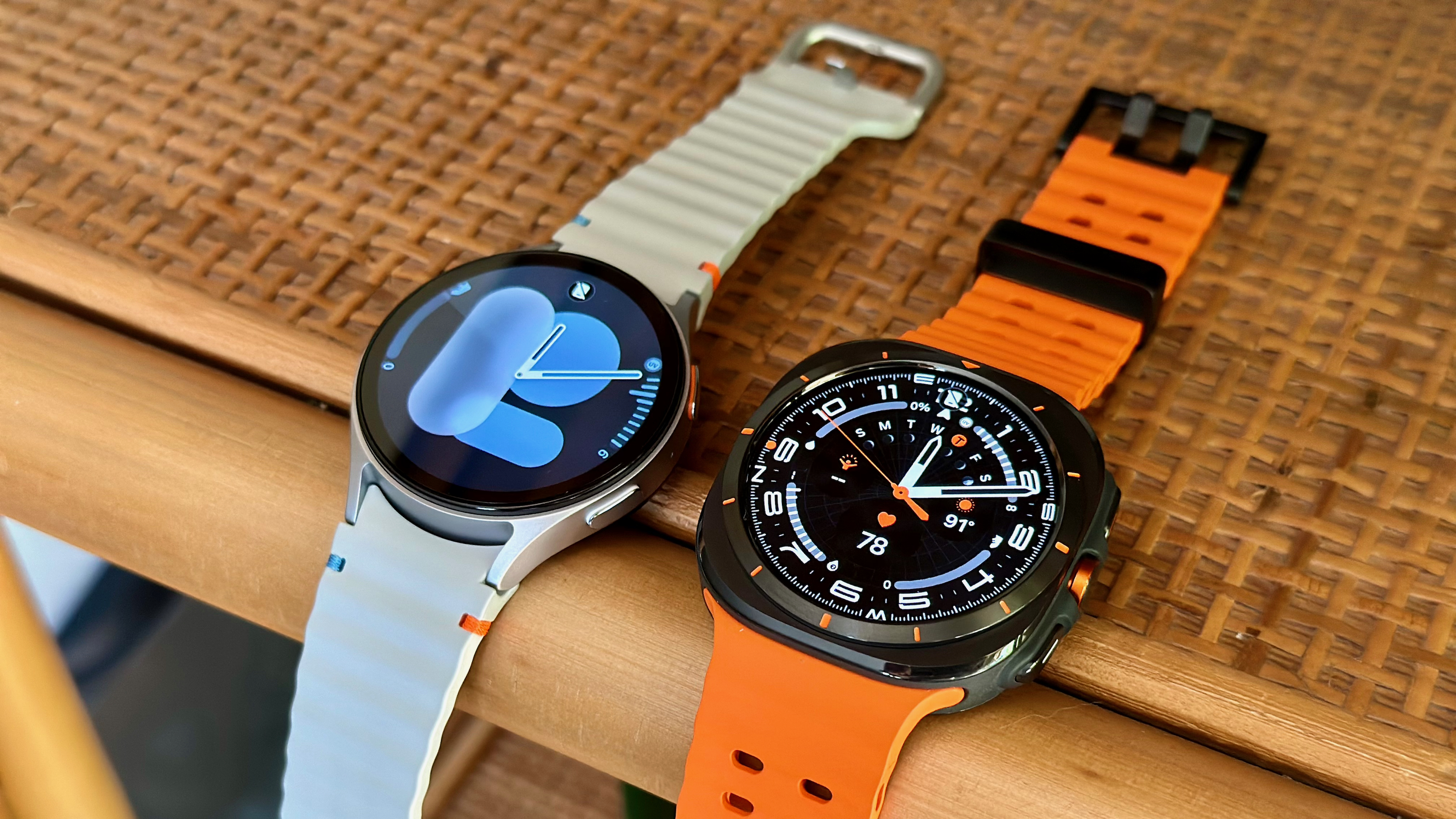 Samsung Galaxy Watch 7 (left, silver) and Samsung Galaxy Watch Ultra (right, black) side by side