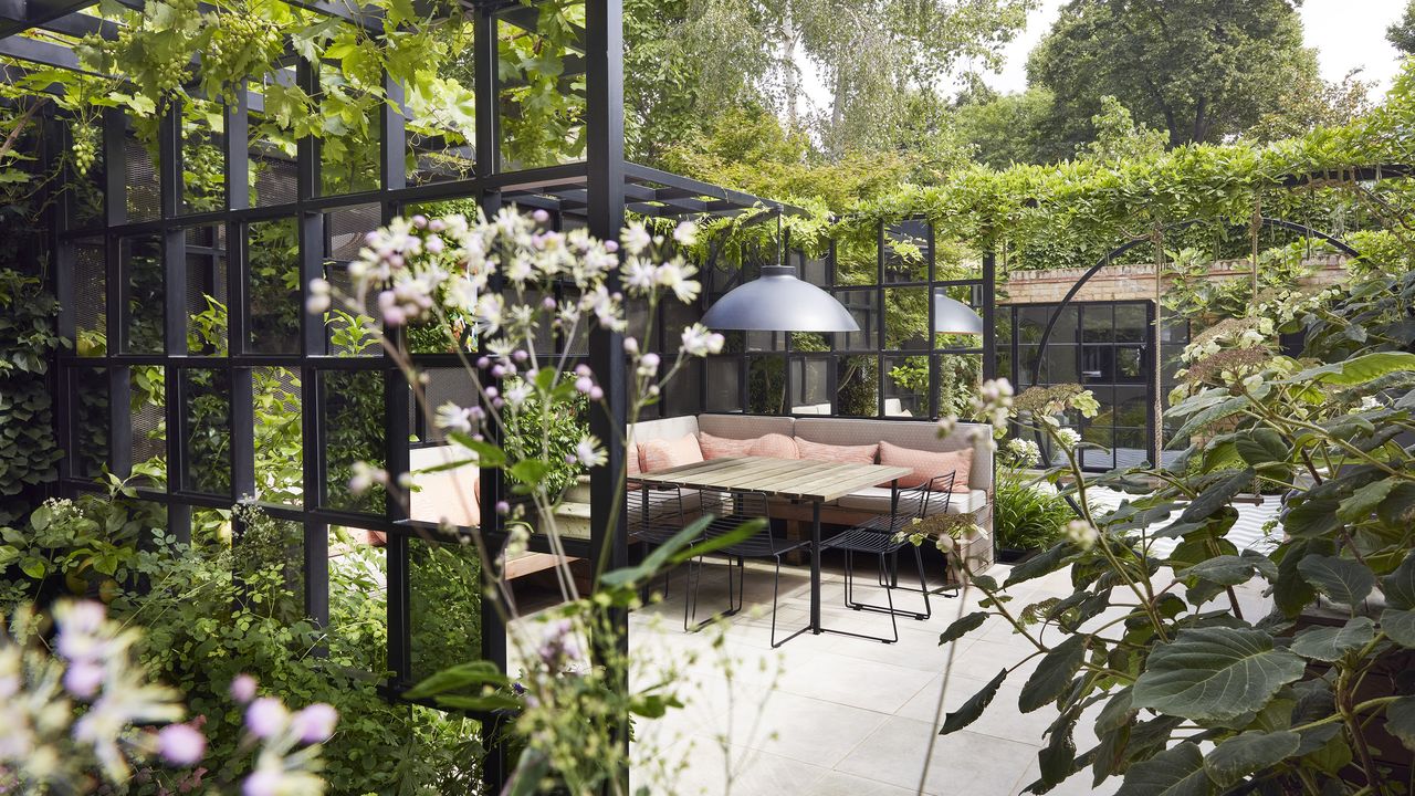 A contemporary town garden zoned with decorative crittal screens