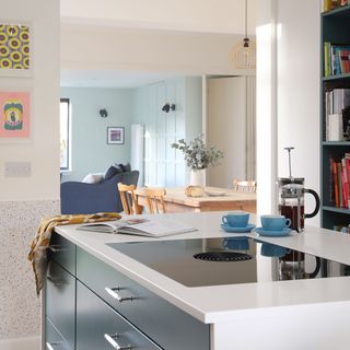 white kitchen island with induction hob and cafetiere