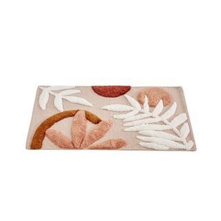 A leaf patterned pink and brown bath mat