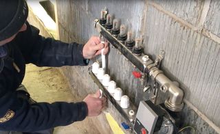 The underfloor heating manifold attached to a wall