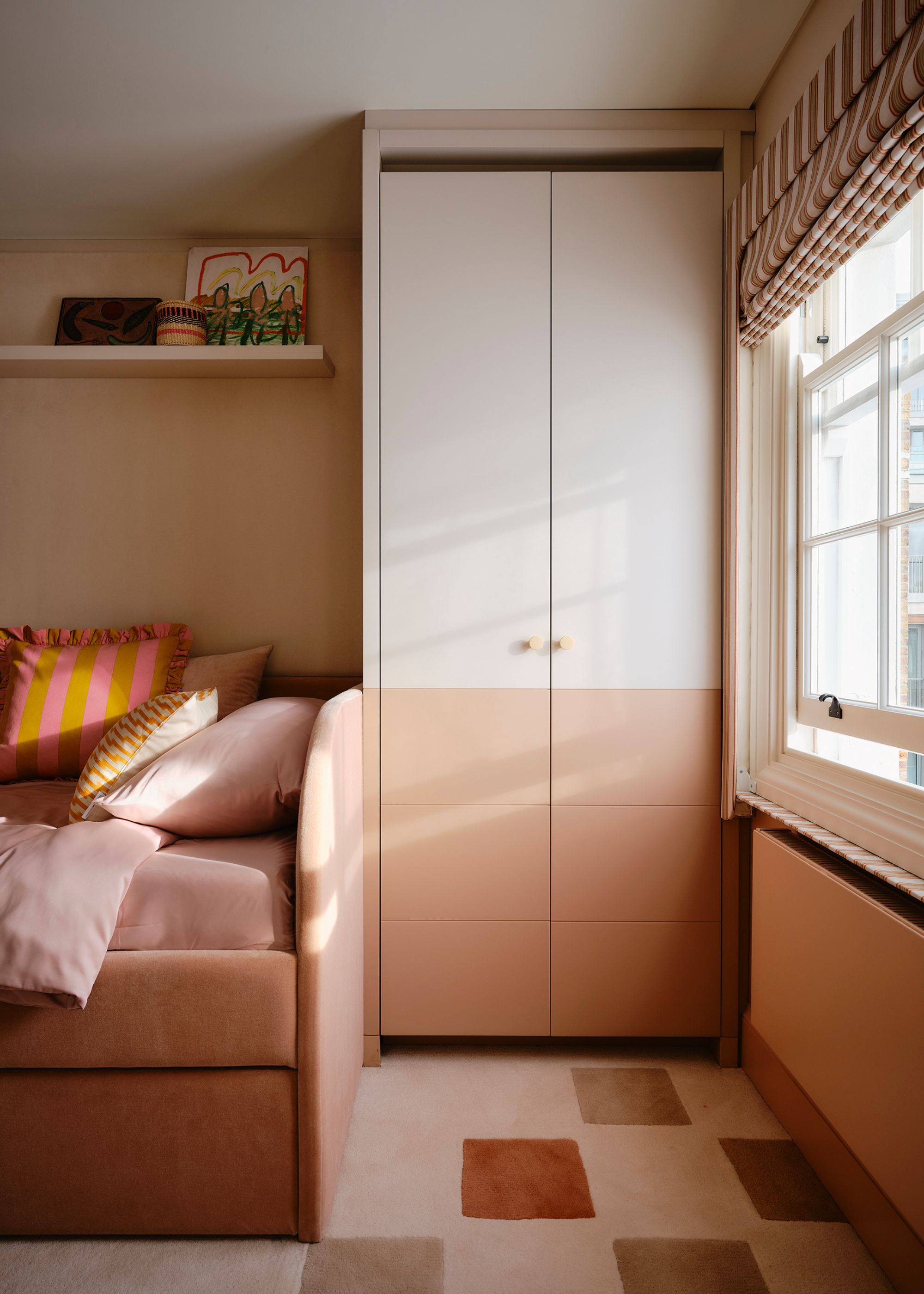 Pale pink bedroom with two-tone wardrobes.