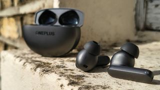 The OnePlus Buds 4 on a window sill.