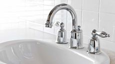 White bathroom with shiny faucets and sink