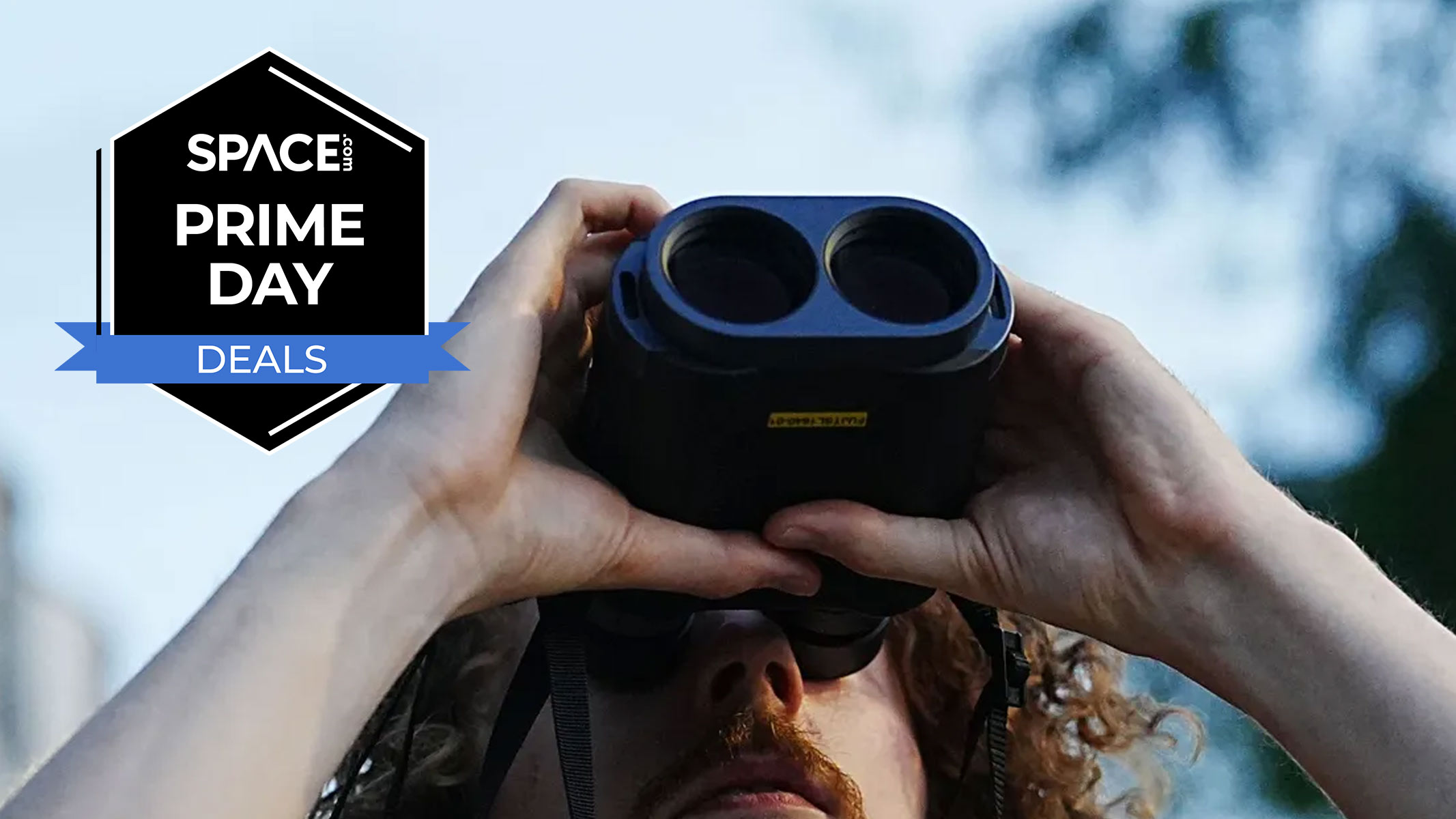 A man looking up through the Fujifilm Techno-Stabi TS-L 1640 image-stabilized binoculars with the sky in the background and a black Space.com Prime Day badge in the upper left corner.